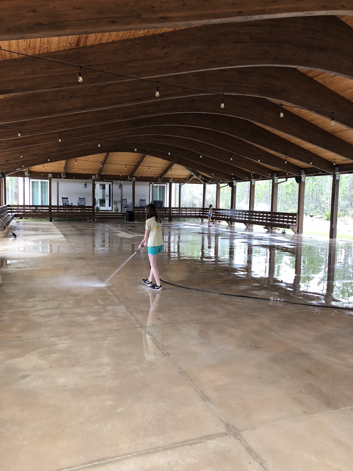 Curated interior view of the pavilion with the open floor ready for a gathering