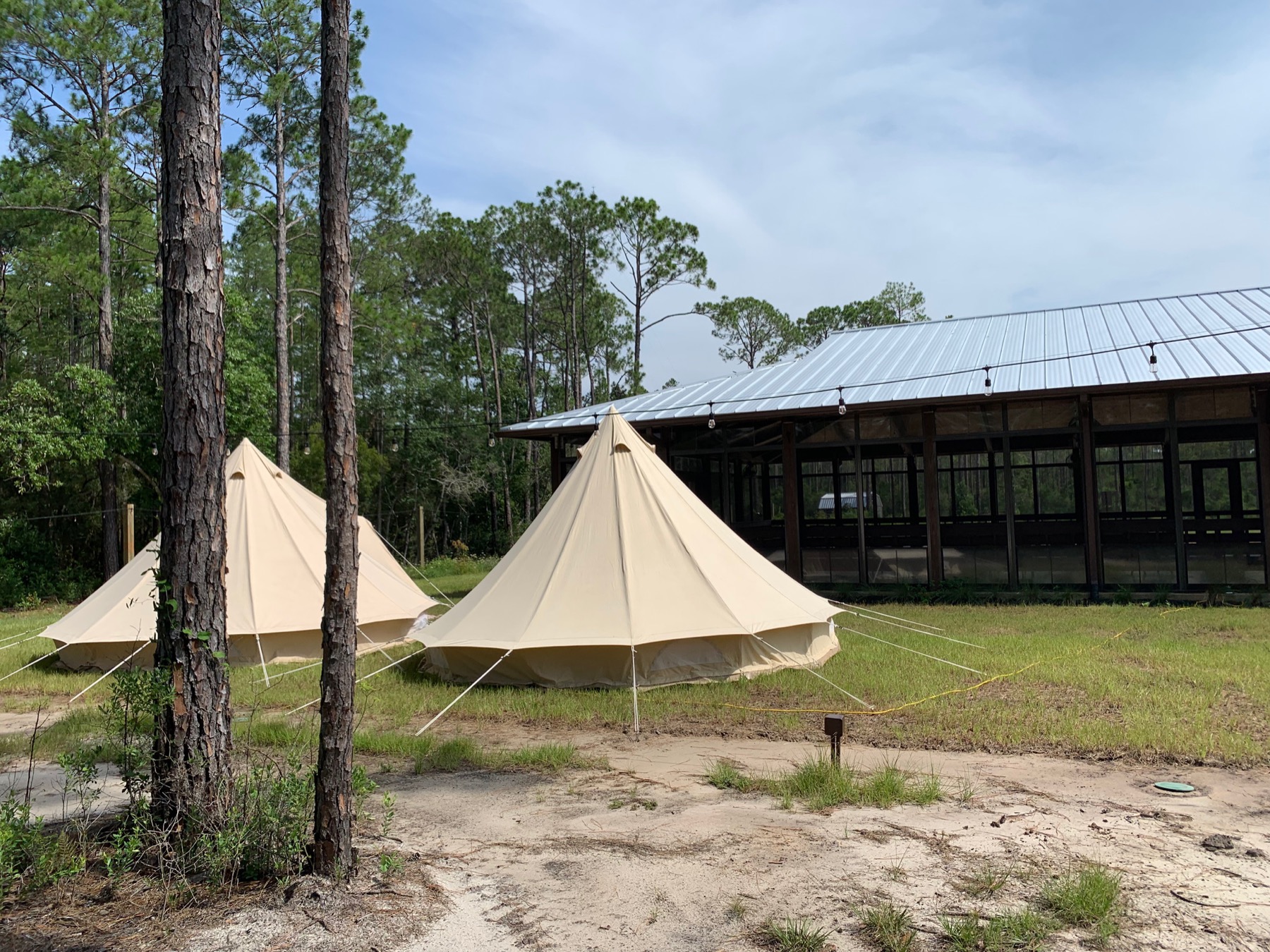Curated bell tent setup beside the pavilion at Point Preserve