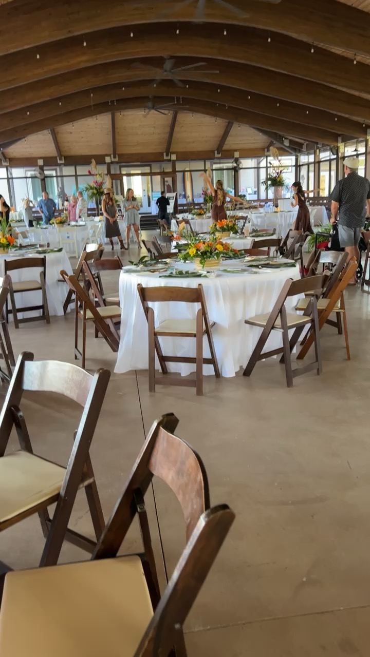 Reception tables being styled inside the pavilion before guests arrive