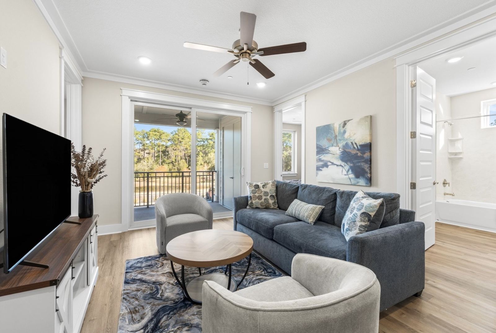 Condo living room with sofa seating and balcony view