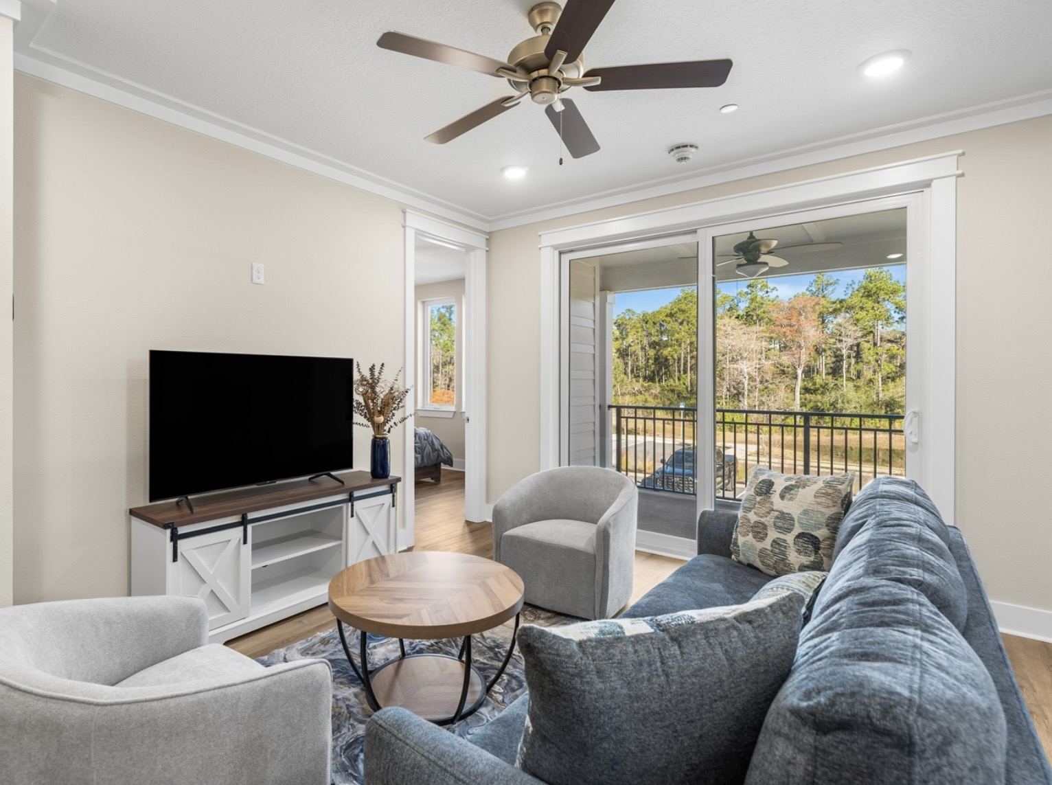 Nearby lodging living room with balcony and forest view